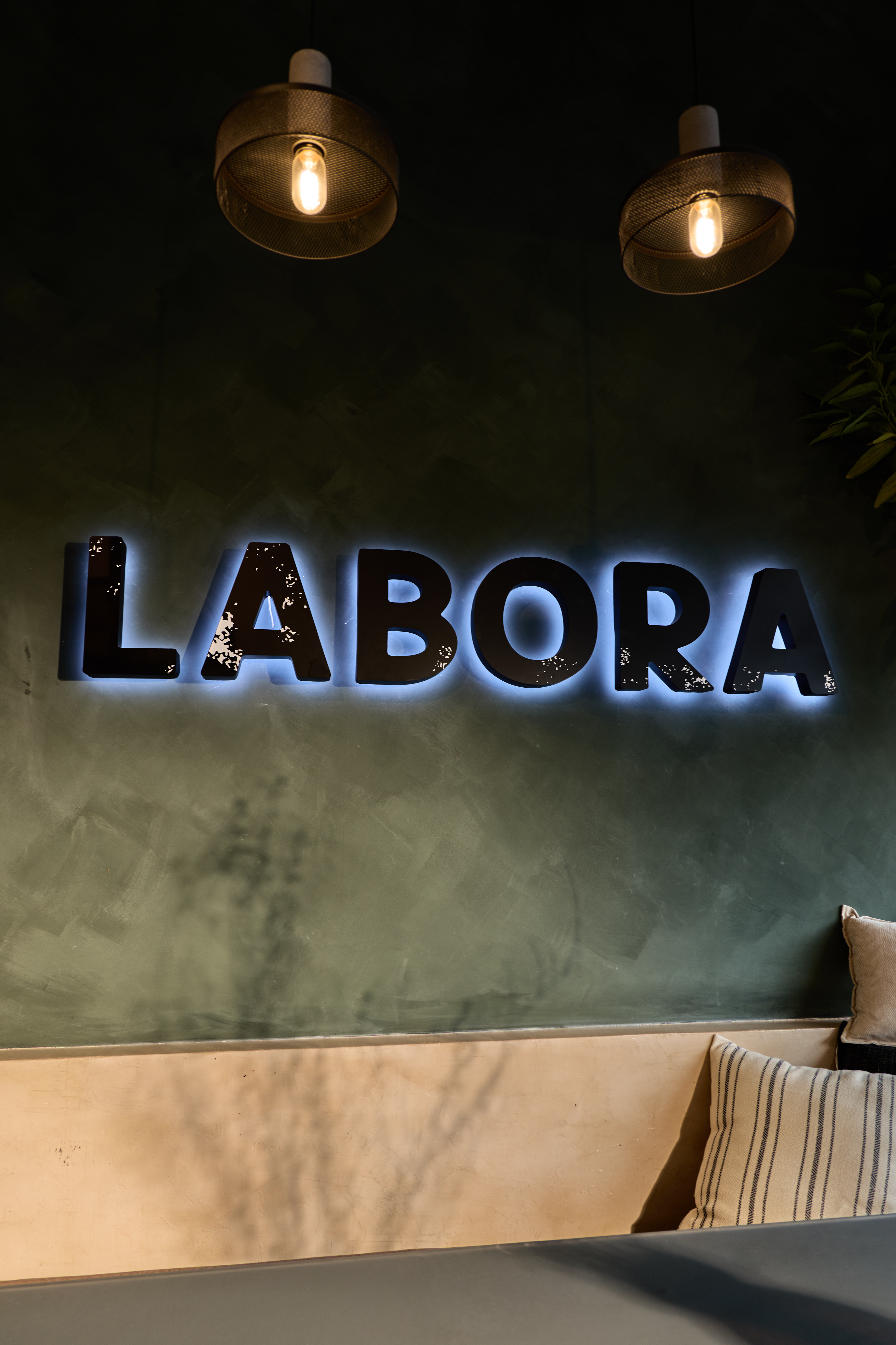The backlit LABORA sign inside the cafe